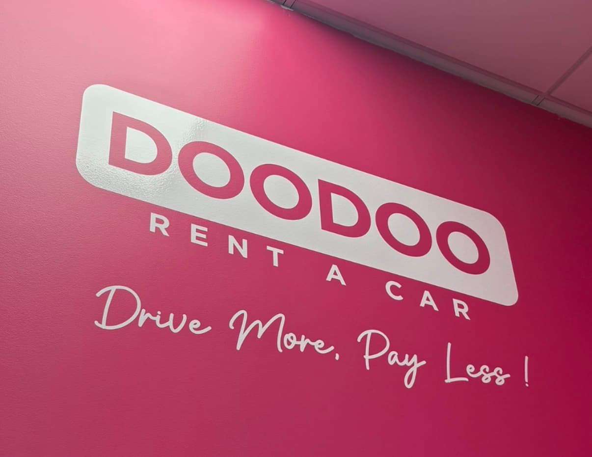 Inside a DOODOO Rent a Car digital corner