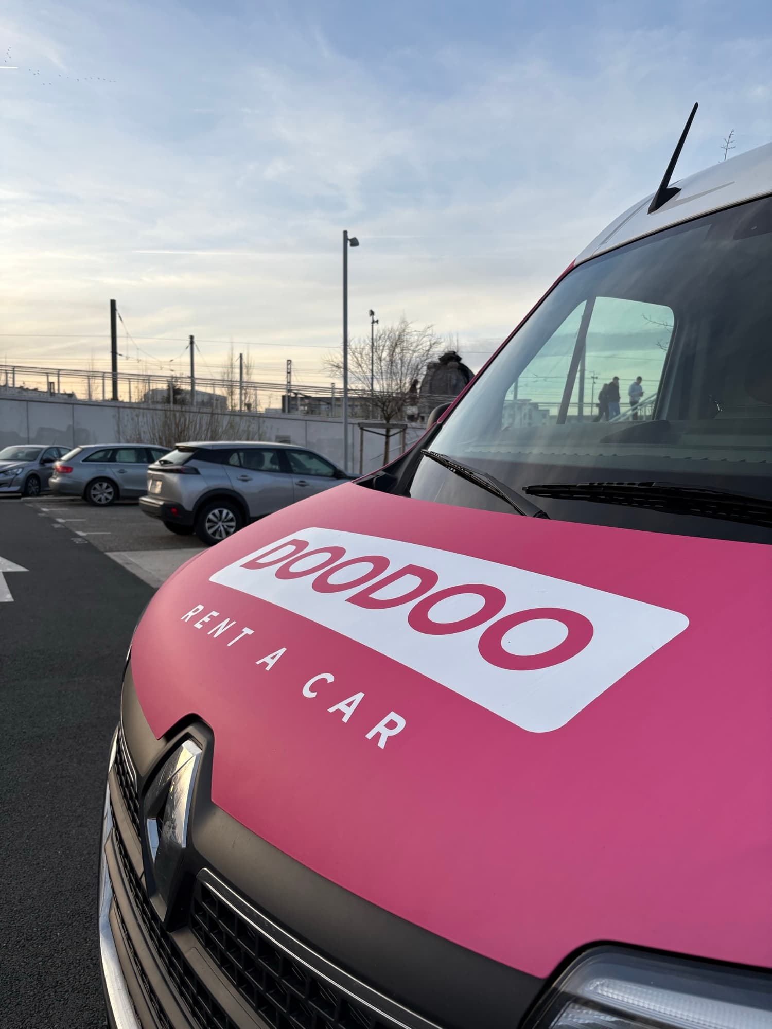 DOODOO Rent a Car branded vehicle at a French train station
